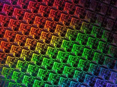 A close view of repeated circuit dies patterned across a silicon wafer