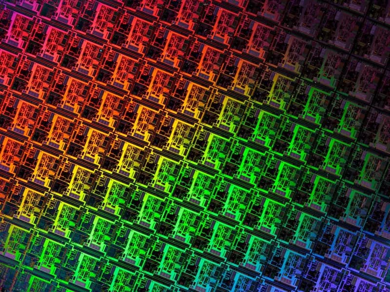 A close view of repeated circuit dies patterned across a silicon wafer