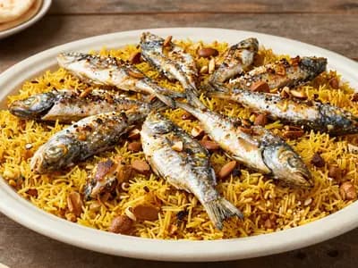 A platter of spiced rice topped with baked fish and almonds