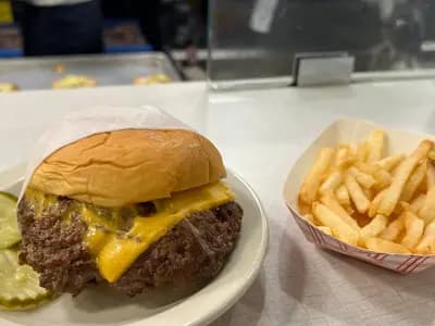 A hamburger and French fries, illustrative of the fast food chains covered and not a specific chain's own product, photographed in March 2024