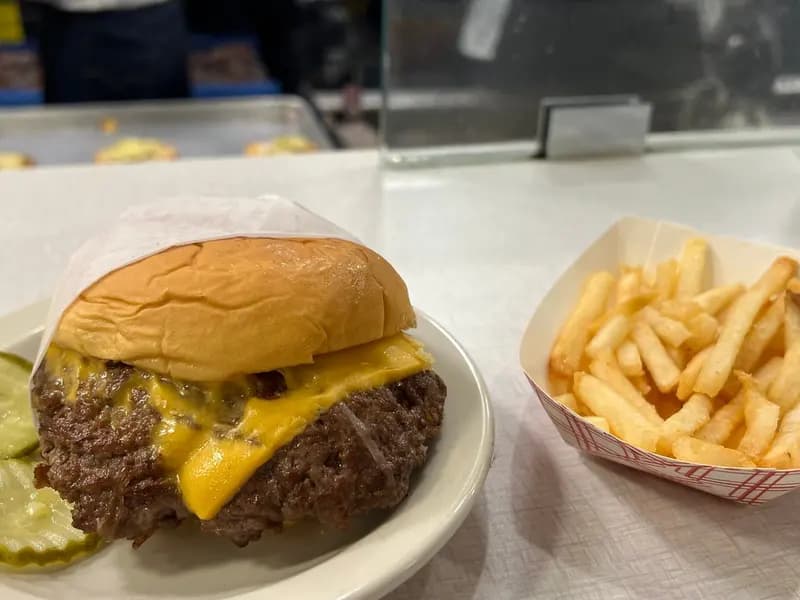 A hamburger and French fries, illustrative of the fast food chains covered and not a specific chain's own product, photographed in March 2024