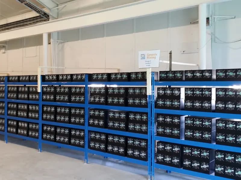 Rows of bitcoin mining machines racked in a cryptocurrency mining facility