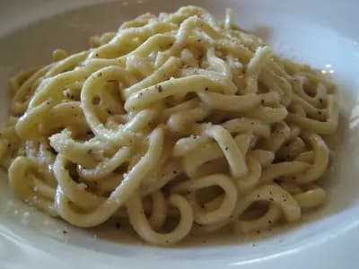 Creamy cacio e pepe pasta with black pepper and Pecorino Romano cheese