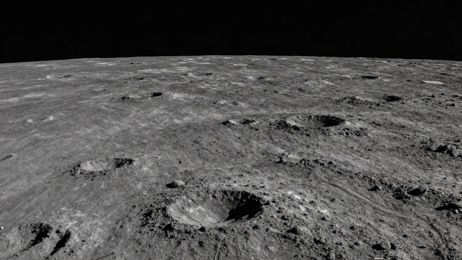 The cratered lunar surface near the pole with long shadows cast across it