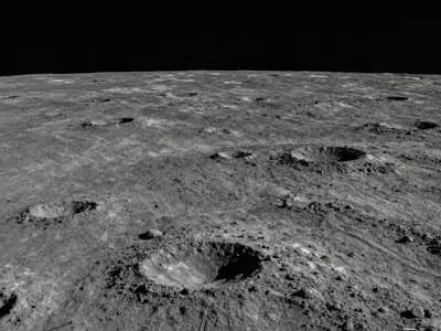 The cratered lunar surface near the pole with long shadows cast across it