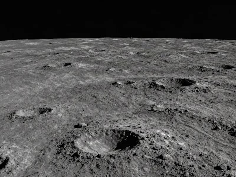 The cratered lunar surface near the pole with long shadows cast across it