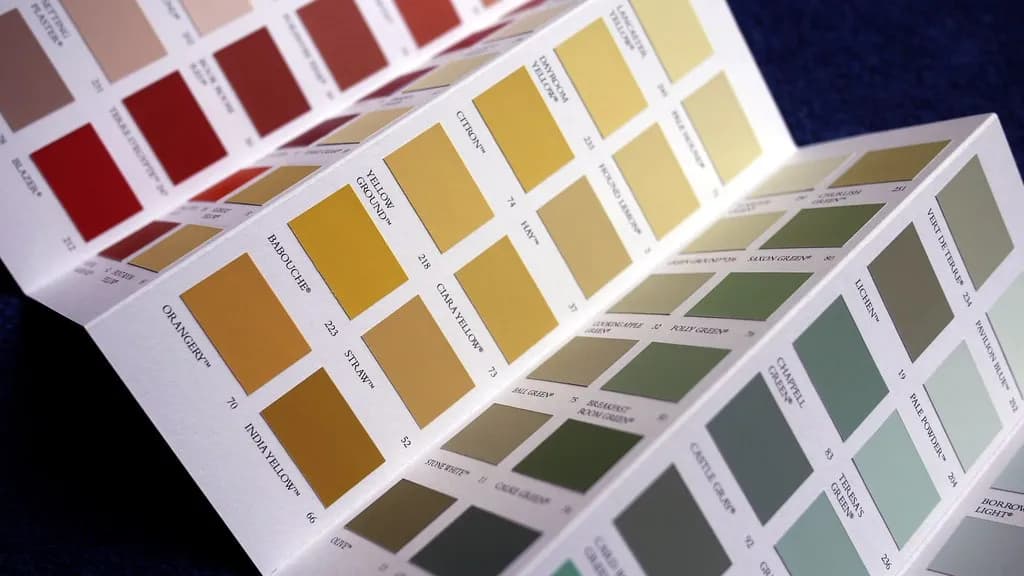 A fan of paint colour cards spread open