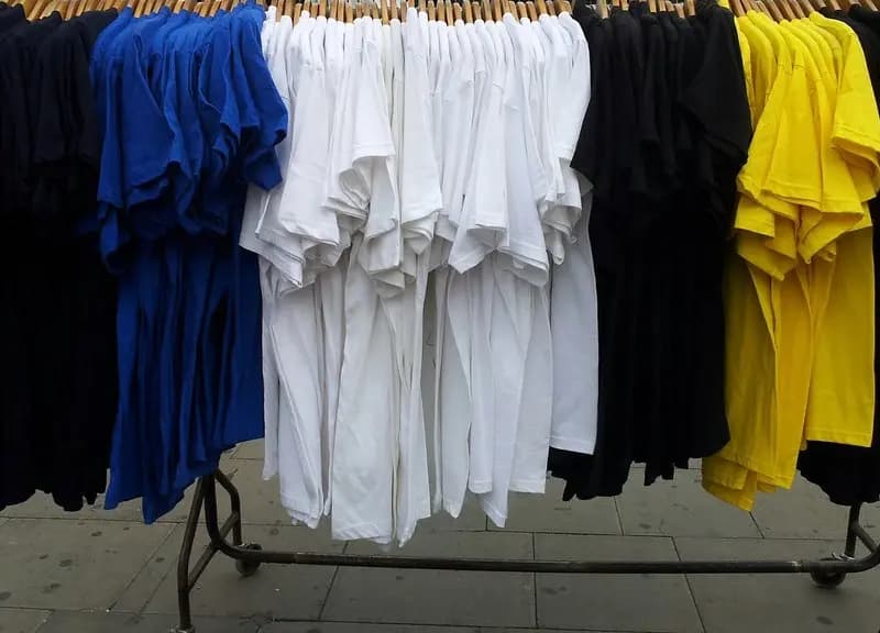 T shirts hanging on a clothes rail at a market stall