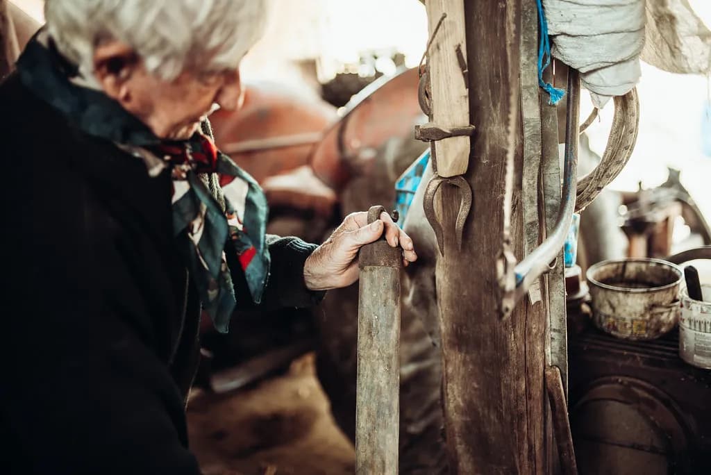 An older craftsperson at work in a traditional workshop