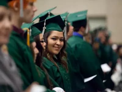 Graduates in caps and gowns at a university ceremony