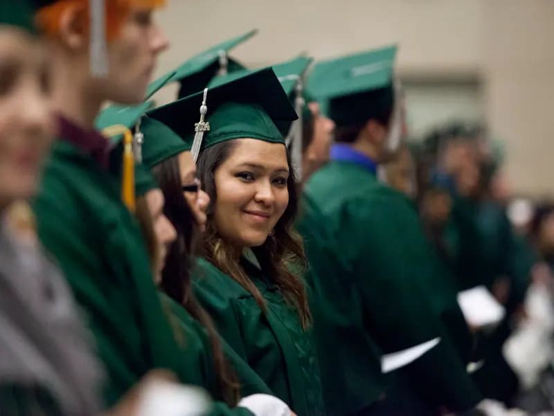 Graduates in caps and gowns at a university ceremony