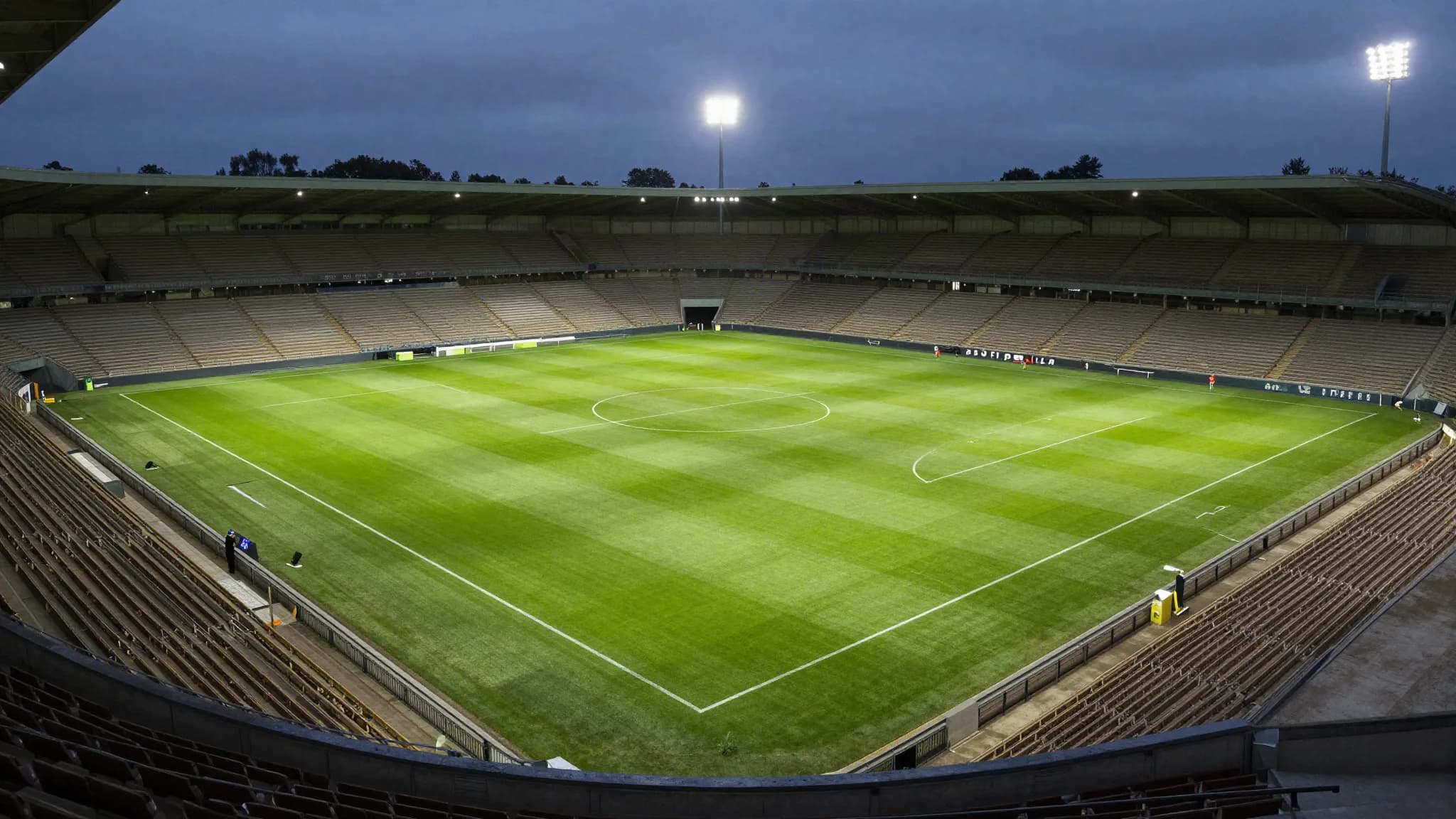 An empty football pitch seen from high in the stands at dusk