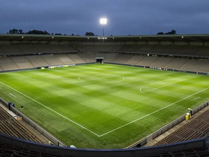 An empty football pitch seen from high in the stands at dusk
