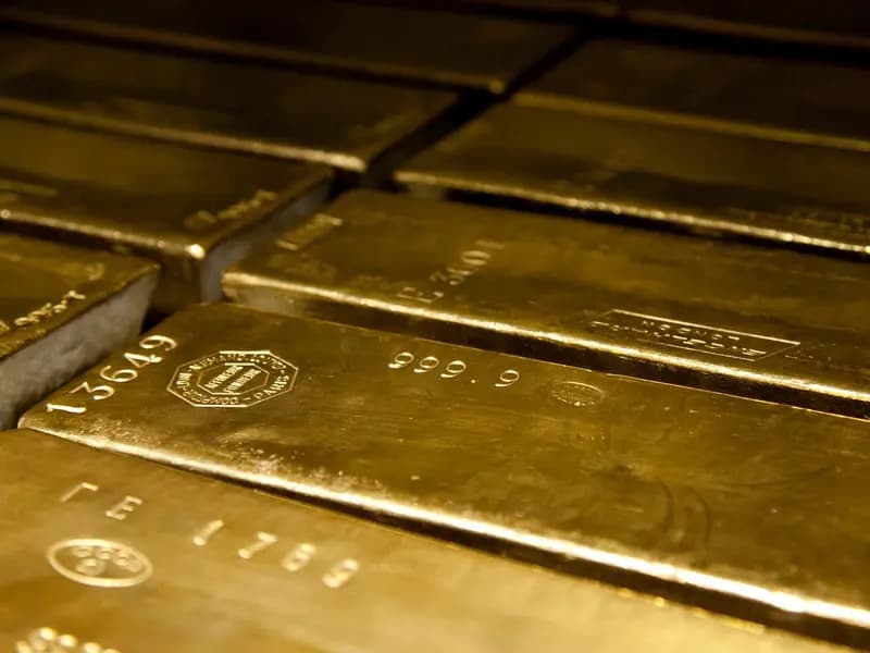 Four hundred ounce gold bars stamped 999.9 fine, stacked in a vault
