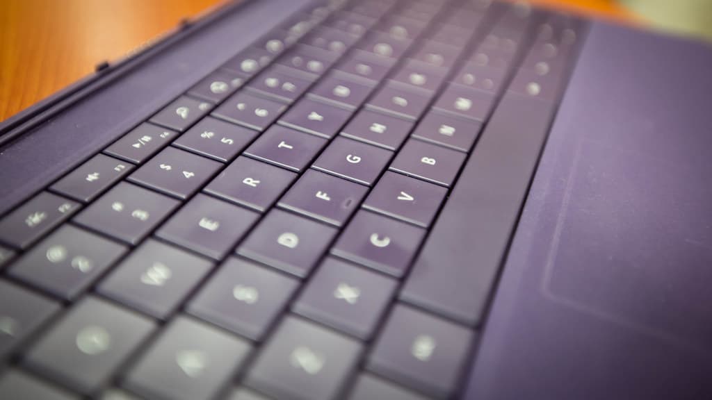 Close-up of a smartphone screen showing a chat assistant app open in a person's hands.