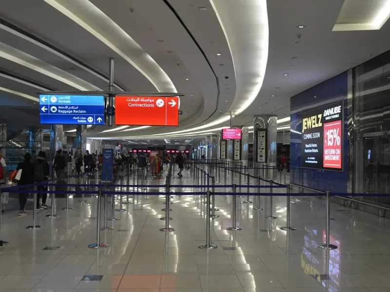 Empty queuing lanes in the Concourse B lobby at Dubai International Airport