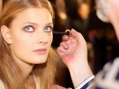 A model having her make-up finished backstage before a Zuhair Murad show in Paris. The house is a guest member of the haute couture calendar