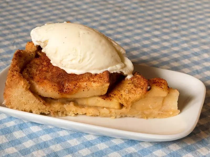 A slice of apple cake with vanilla ice cream, illustrative of the finished bake and not this recipe's own result, photographed in March 2020