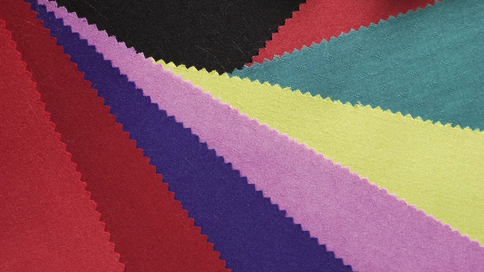Fabric swatches in graded colours with pinked edges