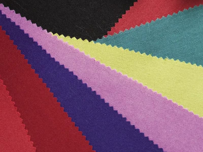 Fabric swatches in graded colours with pinked edges
