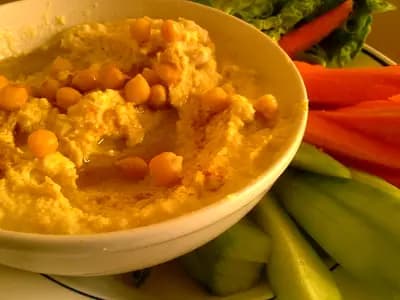 A bowl of silky Lebanese hummus drizzled with olive oil and dusted with paprika