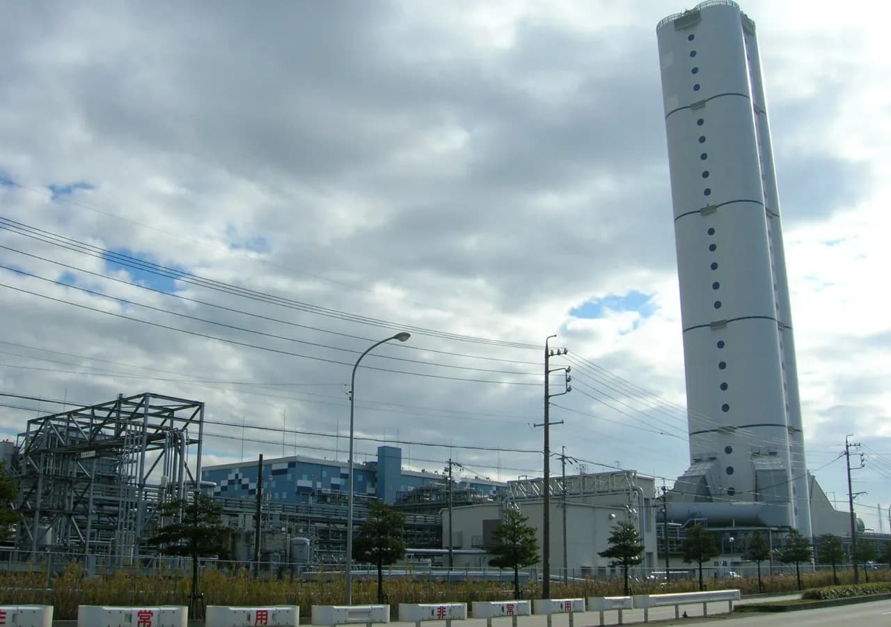 An LNG carrier beside a modern gas and electricity terminal
