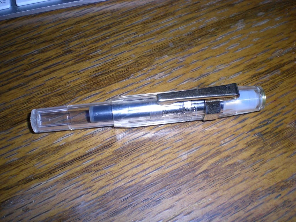 Two unbranded weekly injection pens placed side by side on a clinical white surface
