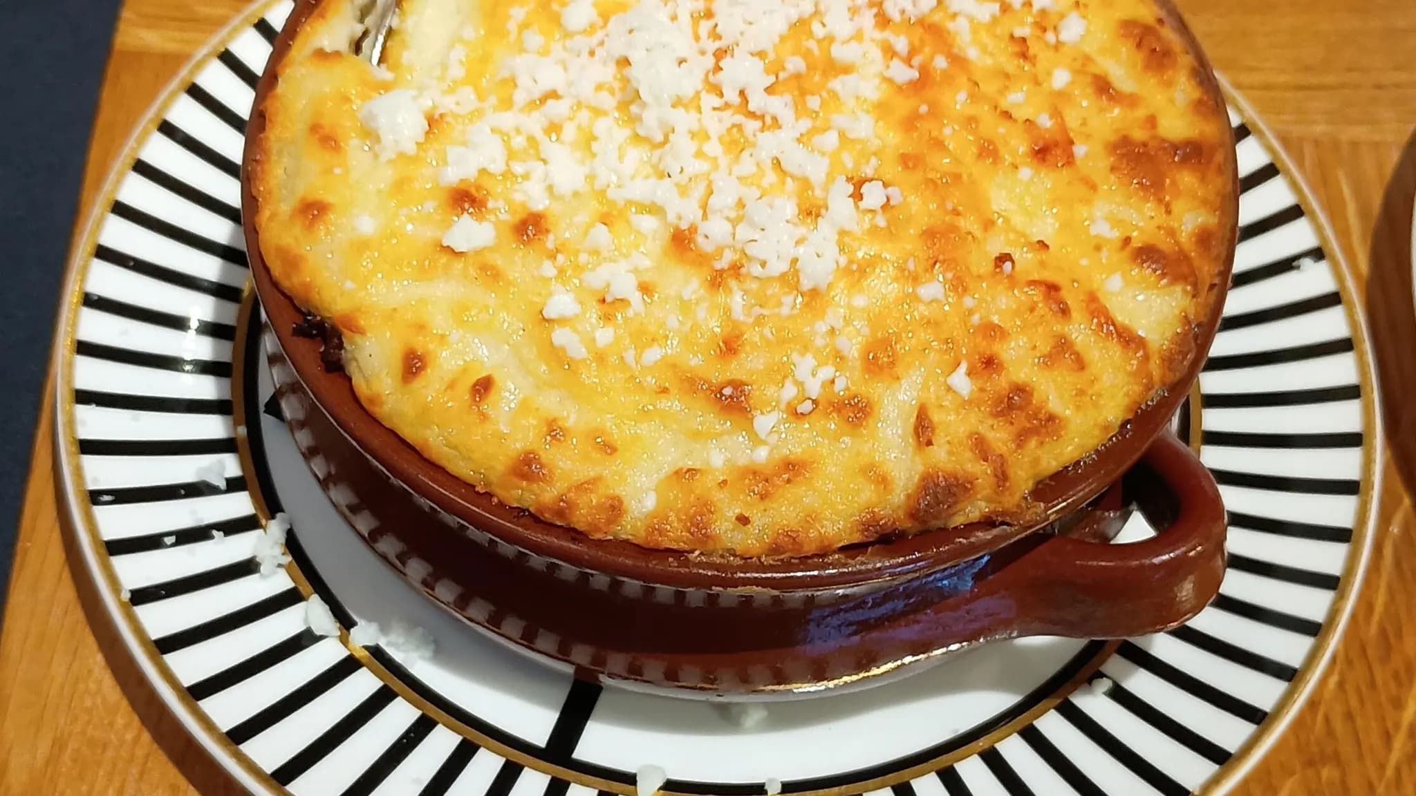 Golden-topped Greek moussaka with layers of eggplant and béchamel sauce