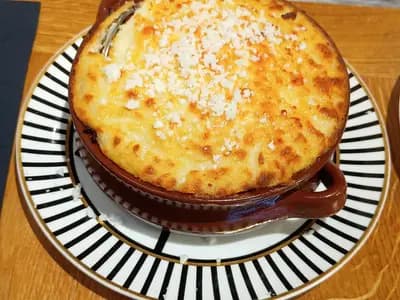 Golden-topped Greek moussaka with layers of eggplant and béchamel sauce