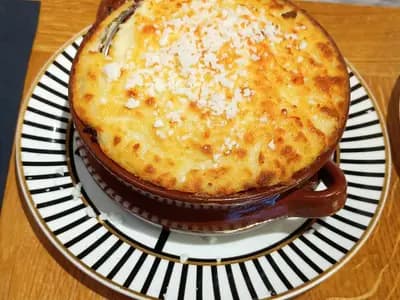 Golden-topped Greek moussaka with layers of eggplant and béchamel sauce