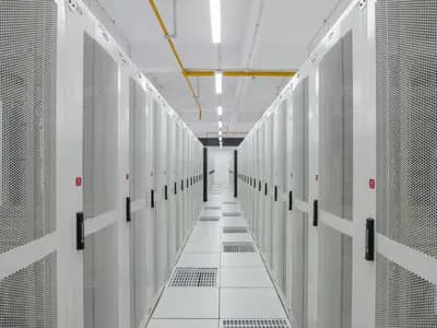 An aisle between rows of server racks in a data centre