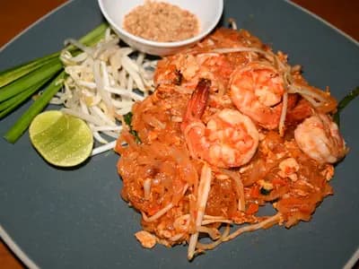 Pad Thai noodles with shrimp, peanuts, and fresh lime