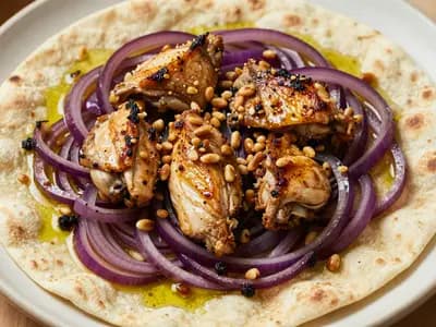 A platter of musakhan, roast chicken over sumac onions and flatbread