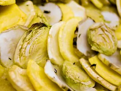 Arranged accordion-style ratatouille vegetables baked golden with tomato piperade