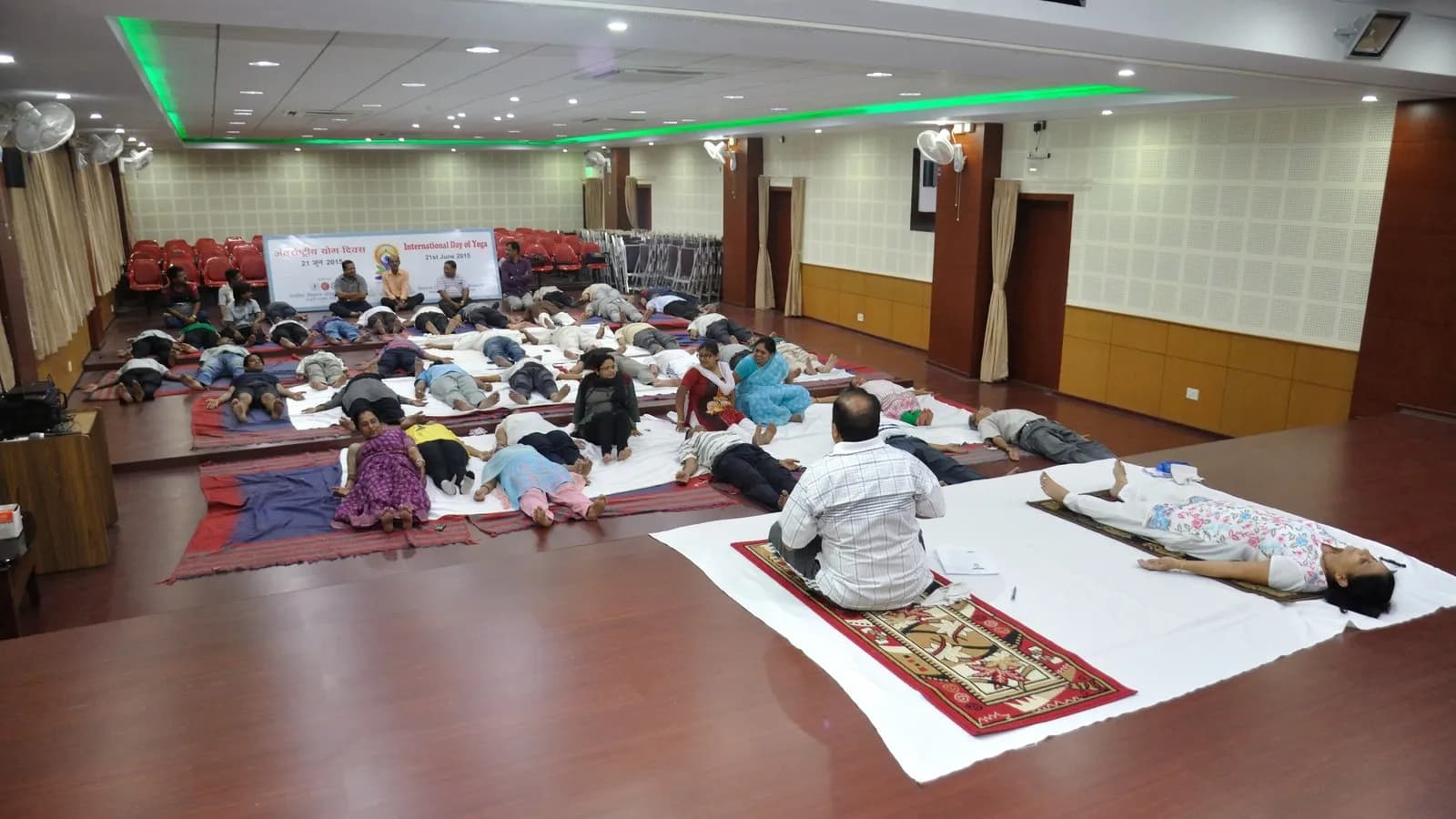 People lying in savasana, the resting pose, at a yoga session in Kolkata in June 2015
