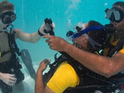 Divers practising scuba emergency procedures in a training pool, in a US Navy photograph from June 2014