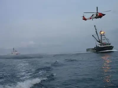 A coast guard rescue vessel at sea during a search and recovery operation, generic and unbranded