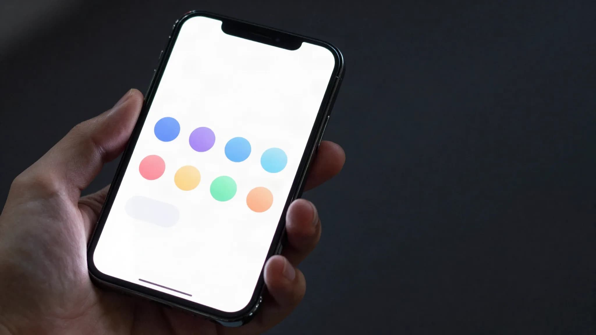 A phone showing a grid of blank app icons