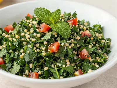 Finely chopped parsley tabbouleh on a white platter