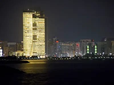 Financial screens overlooking the modern business district in the UAE