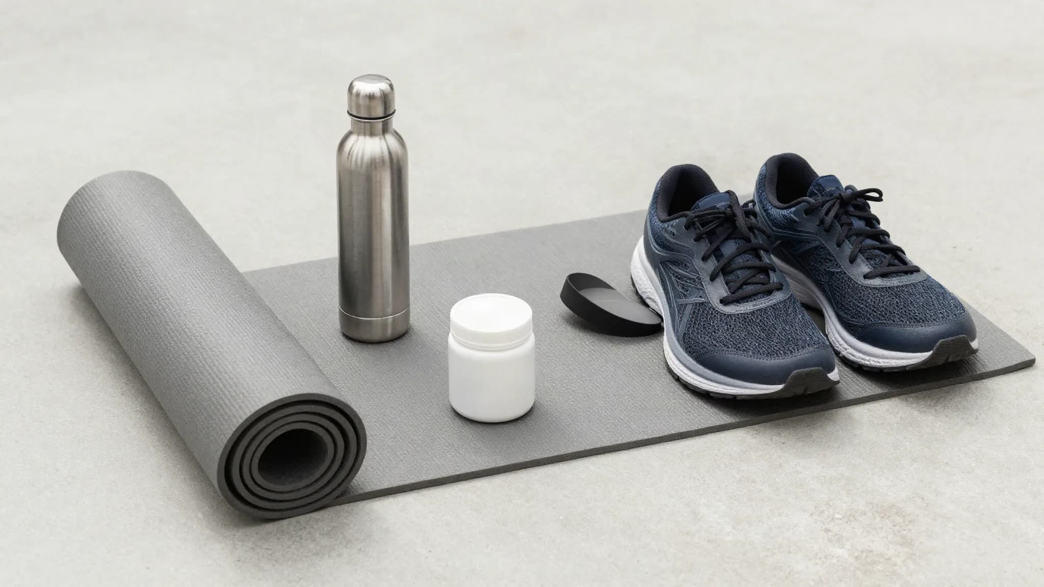 Wellness items arranged on a pale concrete floor