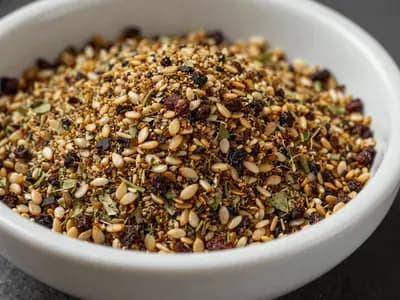 A bowl of za'atar showing distinct green herb, toasted sesame seeds and dark red sumac