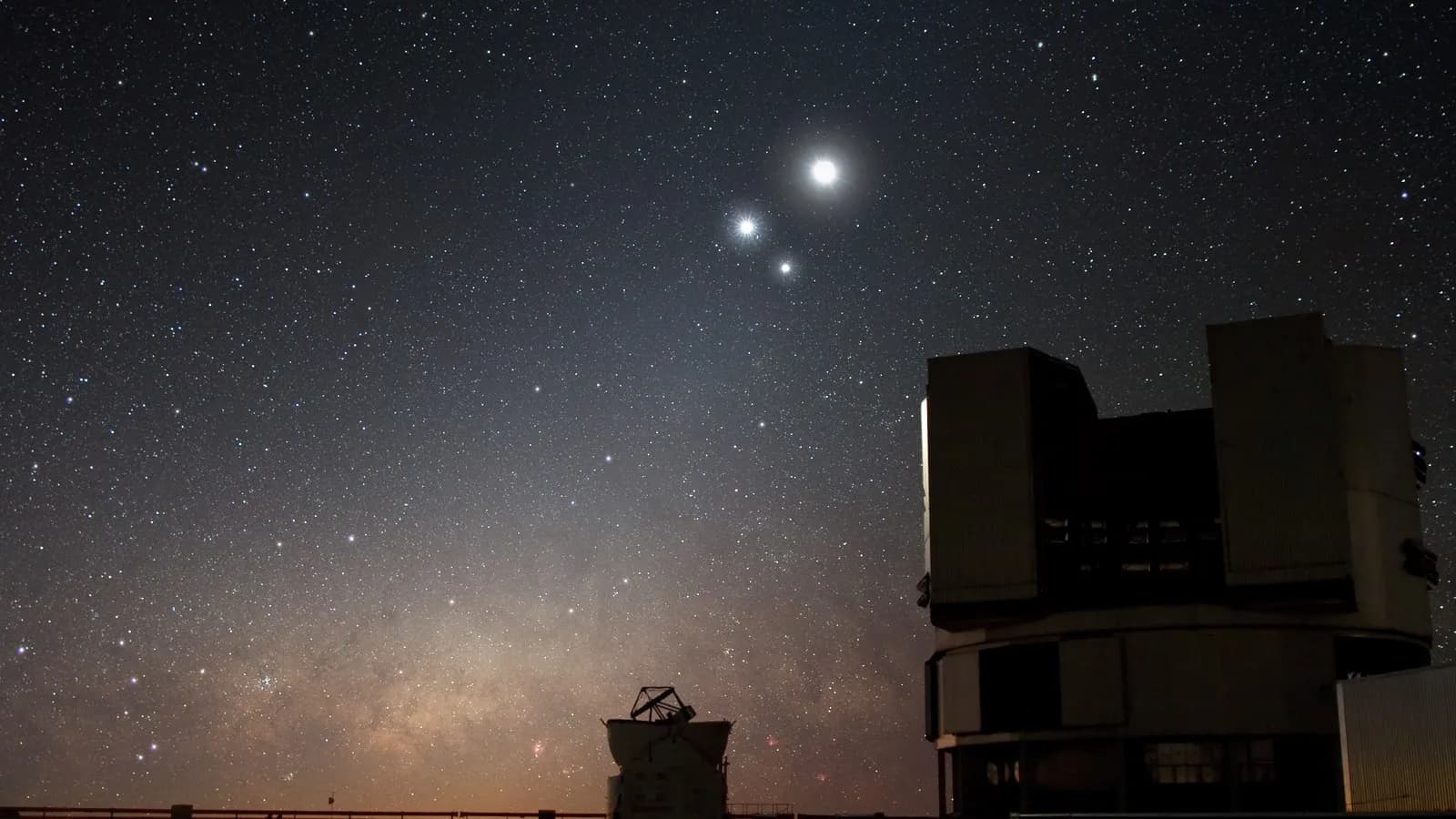 The domes of ESO's Very Large Telescope at Paranal in Chile under the night sky in December 2009; the study used its MUSE spectrograph