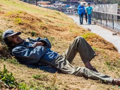 A man taking a siesta on a grassy bank in the San Cristobal district of Cusco, Peru, in July 2015