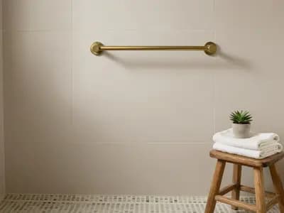 A level access shower with a wall mounted rail and small format floor tiles