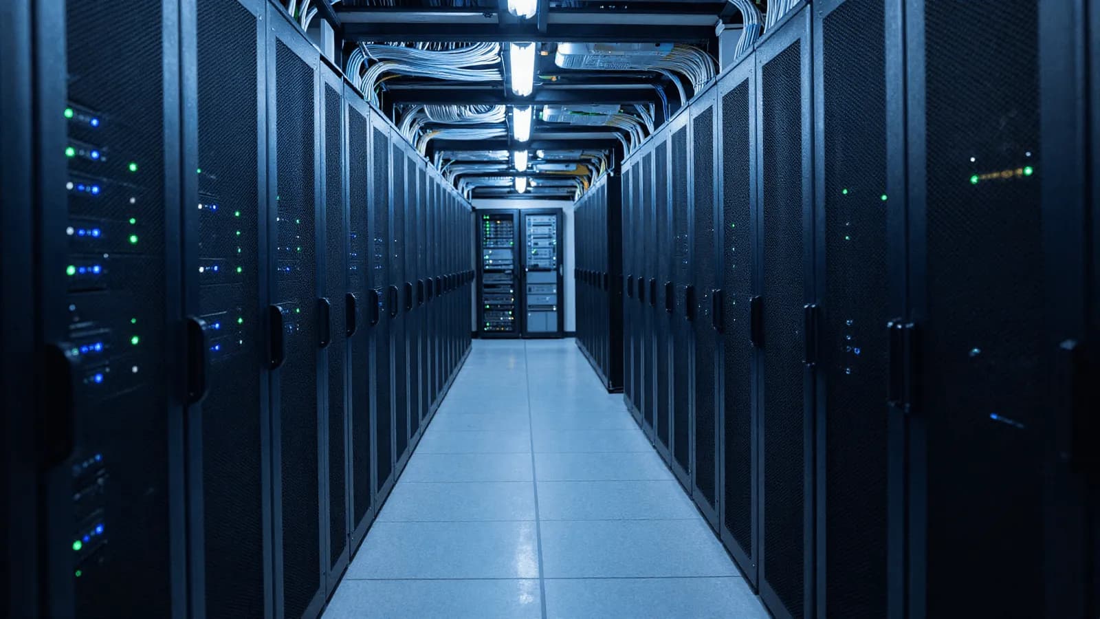 A long corridor of server racks in a data centre