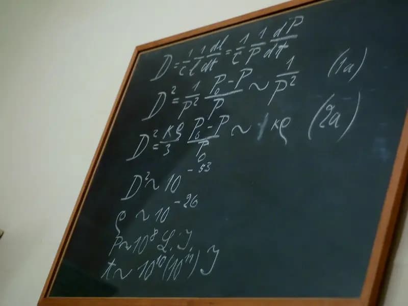 A blackboard covered in handwritten mathematical notation