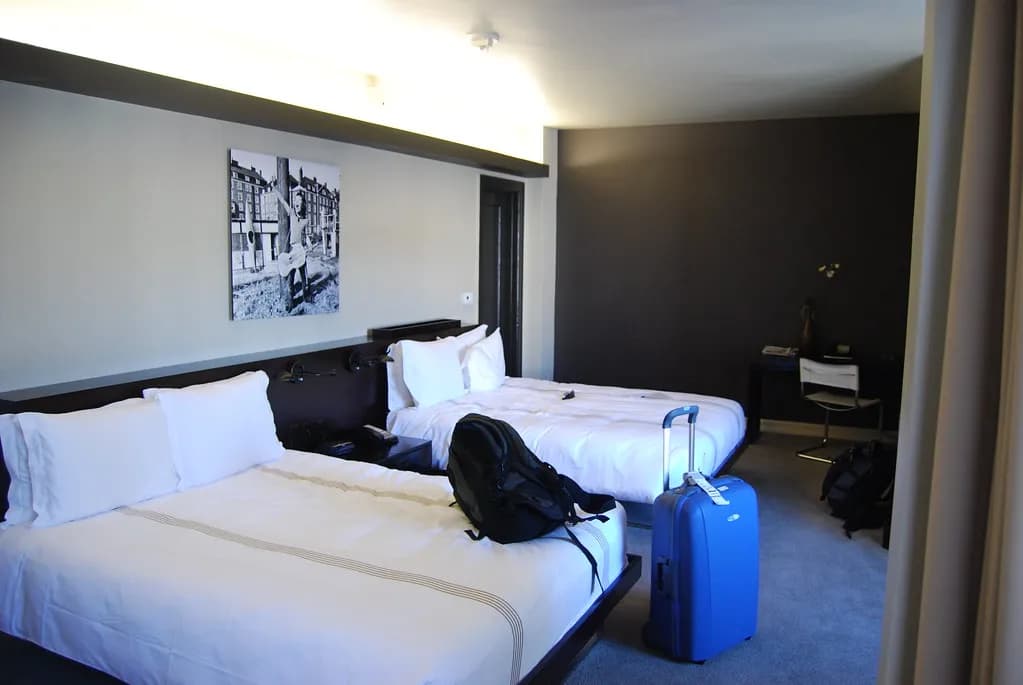 An empty hotel corridor lined with guest room doors