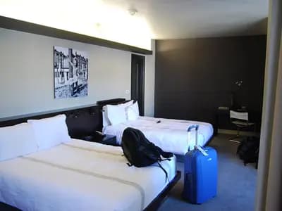 An empty hotel corridor lined with guest room doors