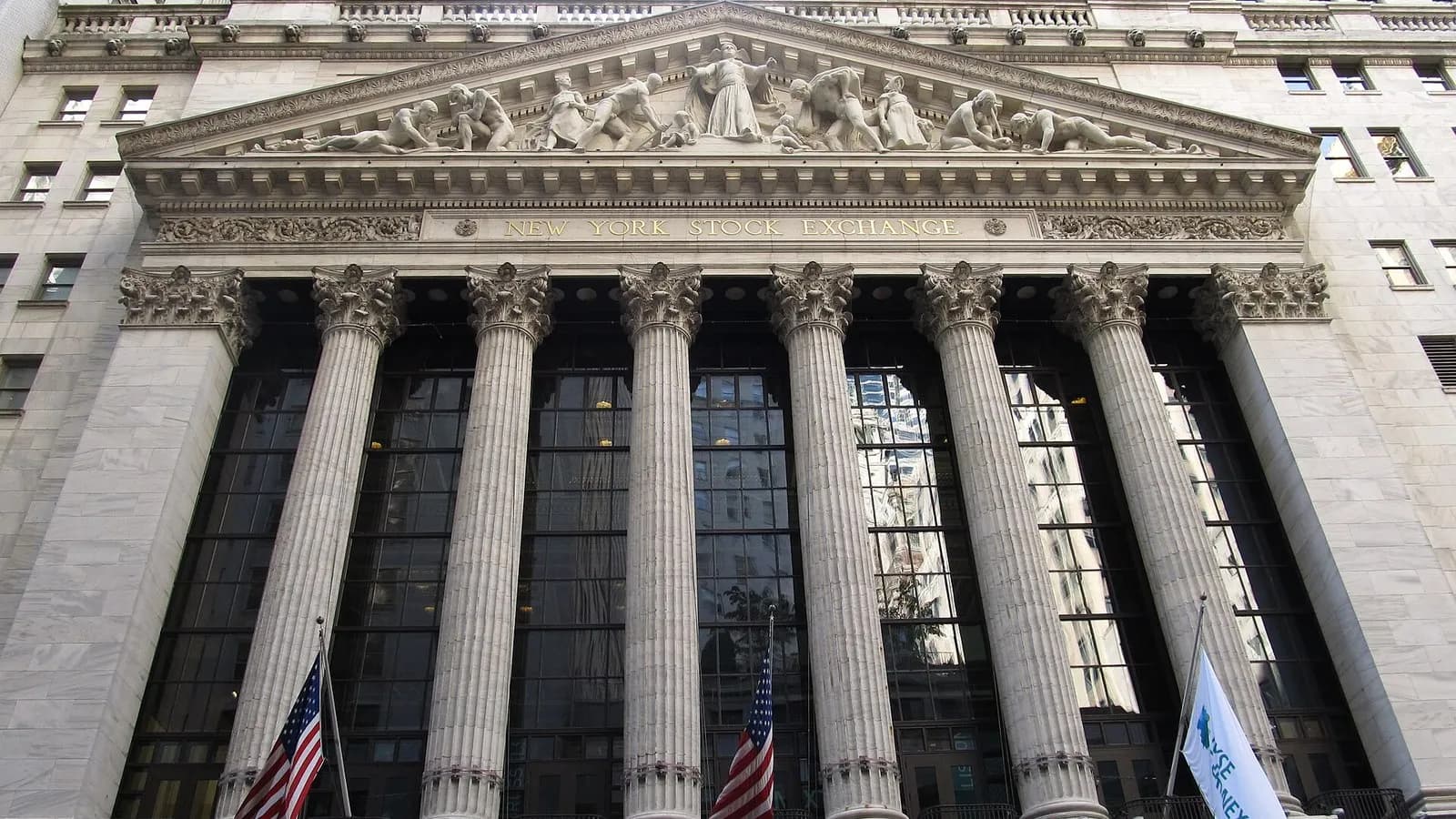 The columned neoclassical front of the New York Stock Exchange at 11 Wall Street in Lower Manhattan with flags below the pediment, photographed on 17 May 2012, a file photograph of the exchange building and not of Thursday's trading